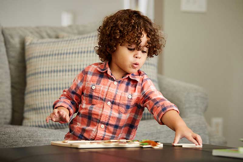 boy playing with puzzle